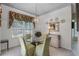 Dining room featuring a glass table, upholstered chairs, and decorative lighting at 6955 Della Dr # 41, Orlando, FL 32819