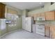 Eat-in kitchen area with white appliances and tile flooring at 6955 Della Dr # 41, Orlando, FL 32819