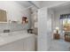 Well-lit laundry area with washer and dryer, storage shelf and access to additional rooms at 6955 Della Dr # 41, Orlando, FL 32819