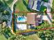 Aerial view of property lines, pool, home, and volleyball court at 6969 Edgeworth Dr, Orlando, FL 32819