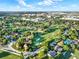 Expansive aerial view of a golf course community, highlighting the integration of homes with green spaces and fairways at 6969 Edgeworth Dr, Orlando, FL 32819