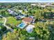 Stunning aerial view of a home featuring a pool and well-manicured yard in a lush, green golf course community at 6969 Edgeworth Dr, Orlando, FL 32819