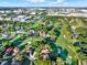 High-angle aerial of a residential area surrounded by lush green golf courses, indicating the location of the property at 6969 Edgeworth Dr, Orlando, FL 32819