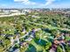 An elevated aerial view of a residential neighborhood, highlighting a golf course and a mix of residential homes at 6969 Edgeworth Dr, Orlando, FL 32819