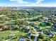 High-angle view of a residential area surrounded by a lush golf course and a lake, showcasing the serene environment at 6969 Edgeworth Dr, Orlando, FL 32819