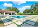 Outdoor space featuring a pool, volleyball court, and covered lanai at 6969 Edgeworth Dr, Orlando, FL 32819