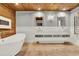 Luxurious bathroom featuring dual sinks, a soaking tub, and modern fixtures at 6969 Edgeworth Dr, Orlando, FL 32819