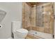 Bathroom featuring a walk-in shower with a glass door and tile surround at 6969 Edgeworth Dr, Orlando, FL 32819