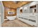 Spa-like bathroom featuring wood-paneled ceilings and walls, a tub, and dual vanity sinks at 6969 Edgeworth Dr, Orlando, FL 32819