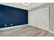 Bedroom featuring light wood floors, fresh paint and a large closet at 6969 Edgeworth Dr, Orlando, FL 32819