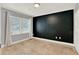 Minimalist bedroom with dark accent wall, large window with blinds, and neutral tones at 6969 Edgeworth Dr, Orlando, FL 32819