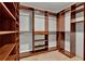 A large walk-in closet featuring custom shelving, drawers, and clothing racks at 6969 Edgeworth Dr, Orlando, FL 32819