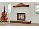 A cozy fireplace featuring a stacked stone surround, wood mantle, and hearth at 6969 Edgeworth Dr, Orlando, FL 32819