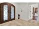 Foyer boasts tile flooring, a decorative front door, and views into other rooms at 6969 Edgeworth Dr, Orlando, FL 32819