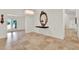 Elegant foyer featuring tile floors, grand mirror, and stylish chandelier at 6969 Edgeworth Dr, Orlando, FL 32819