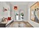Bright entryway featuring a bench and view of the backyard pool at 6969 Edgeworth Dr, Orlando, FL 32819