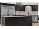 Kitchen island with granite countertops, stainless steel appliances, and custom cabinetry at 6969 Edgeworth Dr, Orlando, FL 32819