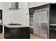 Close-up of a kitchen island featuring a cooktop and stainless steel appliances at 6969 Edgeworth Dr, Orlando, FL 32819