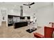 Open-concept kitchen with stainless steel appliances, a central island cooktop, and comfortable living area at 6969 Edgeworth Dr, Orlando, FL 32819