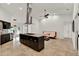The modern kitchen includes a cooktop island with seating, and stainless steel appliances at 6969 Edgeworth Dr, Orlando, FL 32819