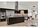 Modern kitchen with stainless steel appliances, a kitchen island with a cooktop, and dark cabinetry at 6969 Edgeworth Dr, Orlando, FL 32819