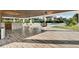 Spacious outdoor living area including a wet bar, dining table, and swimming pool at 6969 Edgeworth Dr, Orlando, FL 32819