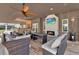 Outdoor living space with stone fireplace and bar, plus comfortable seating area at 6969 Edgeworth Dr, Orlando, FL 32819