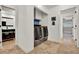 Functional laundry room featuring modern washer and dryer, ample storage cabinets, and stylish tile flooring at 6969 Edgeworth Dr, Orlando, FL 32819