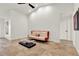 Modern living room with tile flooring, high ceilings and a sleek glass coffee table at 6969 Edgeworth Dr, Orlando, FL 32819