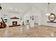 Bright open-concept living room features a brick fireplace, tile floors, and stylish decor at 6969 Edgeworth Dr, Orlando, FL 32819