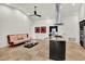 Open concept living area boasts tile floors and modern accents, connecting the living and kitchen at 6969 Edgeworth Dr, Orlando, FL 32819