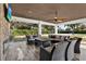 Relaxing patio seating area with an outdoor television and ceiling fan, perfect for watching a game at 6969 Edgeworth Dr, Orlando, FL 32819