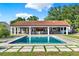 Backyard featuring a beautiful pool, lanai, bar, and manicured lawn at 6969 Edgeworth Dr, Orlando, FL 32819