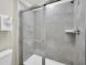Clean bathroom featuring a glass enclosed shower and tiled walls, offering modern simplicity at 7263 Oakmoss Loop, Davenport, FL 33837