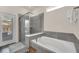 Clean bathroom with a glass shower, tub and outdoor access at 7263 Oakmoss Loop, Davenport, FL 33837