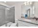 Bathroom with granite counters, white cabinets, shower and toilet, and chrome fixtures at 7263 Oakmoss Loop, Davenport, FL 33837
