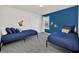 Comfortable bedroom with carpet, bright walls and two twin beds at 7263 Oakmoss Loop, Davenport, FL 33837