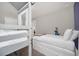 bedroom with gray framed bunk beds, twin bed, Frozen themed bedding, and gray carpet at 7263 Oakmoss Loop, Davenport, FL 33837