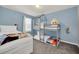 bedroom with bunk beds and twin bed, Frozen themed bedding, blue wall accents and carpeted floors at 7263 Oakmoss Loop, Davenport, FL 33837
