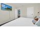 Modern bedroom featuring TV, white walls, gray carpet and two doors, offering natural light at 7263 Oakmoss Loop, Davenport, FL 33837