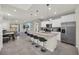 Open concept kitchen with stainless appliances, island seating and easy access to the living area at 7263 Oakmoss Loop, Davenport, FL 33837