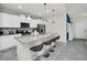 Modern kitchen with stainless steel appliances, granite countertops, and bar stool seating at 7263 Oakmoss Loop, Davenport, FL 33837