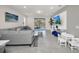 Open concept floor plan features a sunlit living area with a view of the backyard pool at 7263 Oakmoss Loop, Davenport, FL 33837