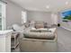 Cozy living room area with large windows and comfortable seating at 7263 Oakmoss Loop, Davenport, FL 33837