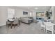 Sunlit living area with dining set, view of the outdoor pool area, and large gray sectional at 7263 Oakmoss Loop, Davenport, FL 33837