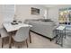 Bright living room with a view of the outdoor pool area and a marble table set at 7263 Oakmoss Loop, Davenport, FL 33837