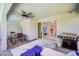 Relaxing covered patio featuring a ceiling fan, outdoor seating, and access to indoor living spaces at 7263 Oakmoss Loop, Davenport, FL 33837