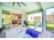 Covered patio with lounge chairs and outdoor grill offering an ideal space for relaxation and entertainment at 7263 Oakmoss Loop, Davenport, FL 33837