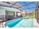 Backyard oasis featuring a screened pool and spa alongside a covered patio for outdoor enjoyment at 7263 Oakmoss Loop, Davenport, FL 33837