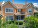 Rear exterior view featuring an upper balcony and large windows providing natural light at 7323 Cypress Grove Rd # 87, Orlando, FL 32819